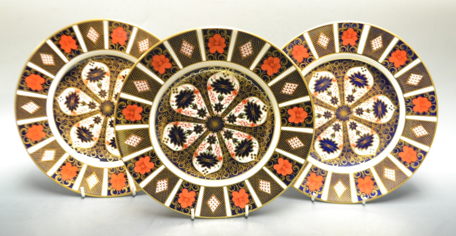 A pair of Royal Crown Derby Imari 1128 pattern dinner plates; another similar,
