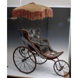 An early Victorian Parker Brothers three wheel coach built pram, black curved body,