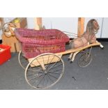 A fine museum quality Victorian Galloping Horse carved wooden and wicker push chair;