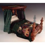 A Victorian mahogany dolls half tester bed, turned and carved foot board, conforming canopy,