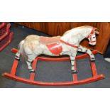 An early 20th century cloth, wood and straw Stuffed Rocking Horse, dappled grey patina,