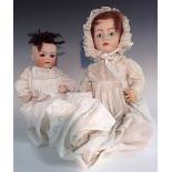 Gebruder Haubach -  a German porcelain head doll, fixed blue eyes, red/brown wig,