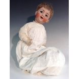 A Simon & Halbig bisque head baby doll, blue weighted eyes, open mouth showing two upper teeth,