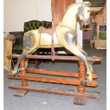 A late 19th/early 20th century Rocking Horse, dappled grey patina, leather saddle, horse hair main,