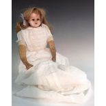 A 19th century wax head shoulder doll, cloth body, leather arms, sleeping brown eyes,