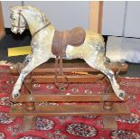 A late 19th/early 20th century Rocking Horse, dappled grey patina, leather saddle, horse hair main,