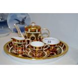 A Royal Crown Derby 1128 miniature coffee service, comprising coffee pot and cover, cup and saucer,