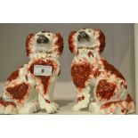 A pair of late 19th century Staffordshire spaniels , rust coat markings , free standing fore legs ,