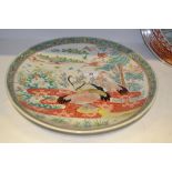 A Japanese charger, decorated with cranes, standing and in flight, bamboo and stylised foliage,