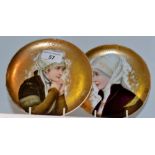 A pair of 19th century cabinet plates, decorated in gilt,