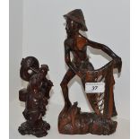 An Oriental hardwood carving of a Fisherman;
