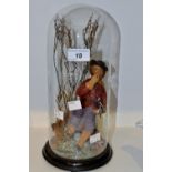 A Victorian diorama of a gentleman collecting wood in winter landscape, under a clear glass dome,