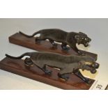 A pair of Chinese ebonised tigers, prowling,