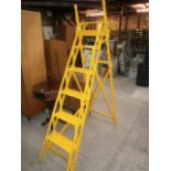set of painted stepladders yellow