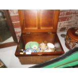 wicker box containing oriental pottery