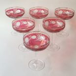 A set of 12 Champagne cranberry coupes in red etched glass with original box. H12cm W6cm