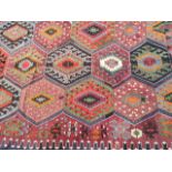 A late C19th Kelim Carpet with multicoloured geometric central lozenges with repeatingstep design