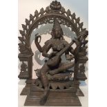 An Indian bronze figure of Saraswati deity seated on lotus base with garland surround playing