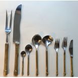 A set designer brass and brushed steel place mats, coaster with cutlery set consisting of 12 pieces.