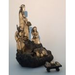 A C19th Meiji Period (1688-1912) Japanese Okimono Ivory group monkeys beside maiden with frogs on