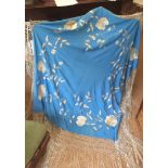 A highly decorative hand embroidered late C19th early C20th blue silk Shawl, with floral