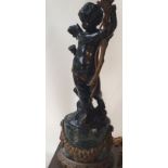 A C19th converted ormolu and marble statue lamp with Putti holding foliate lights on turned marble