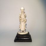 A Japanese Okimono Meiji period ivory figure of a boy monk in robes H17cm W9cm L7cm