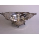 A Chester hallmarked silver pierced basket with scrolling rim and scroll supports H8cm L24.5cm