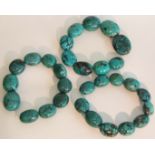 A collection of three turquoise necklasses consisting of 30 polished large turquoise beads