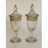 A pair of Victorian glass urns with finial lids florally gilded ( one top AF)H26cm D9cm