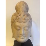 A late C19th/early C20th finely carved head of Guan Yin Bothisvata in marble on square base the head