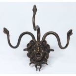 A bronze wall mounted coat hanger: in th