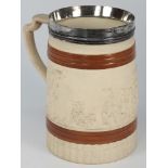 A Turner white stoneware mug: moulded wi