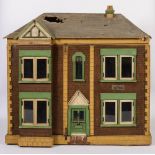 A large early 20th century dolls house,