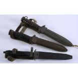 Two US M8A1 style daggers and one other