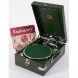 An HMV wind-up gramophone in dark green