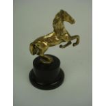 A brass horse mascot:, unsigned, on blac