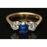 A sapphire and diamond three-stone ring: