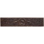 An antique carved oak panel: the central