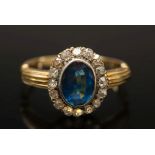 A gold, sapphire and diamond oval cluste