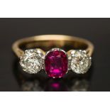 A gold, ruby and diamond three-stone rin