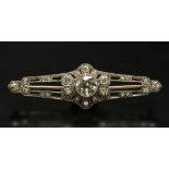 A diamond mounted bar brooch: with centr