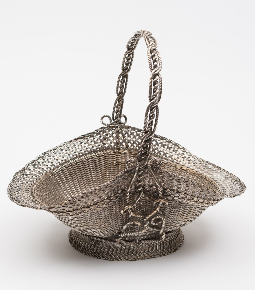 A silver plated fruit basket: of woven w