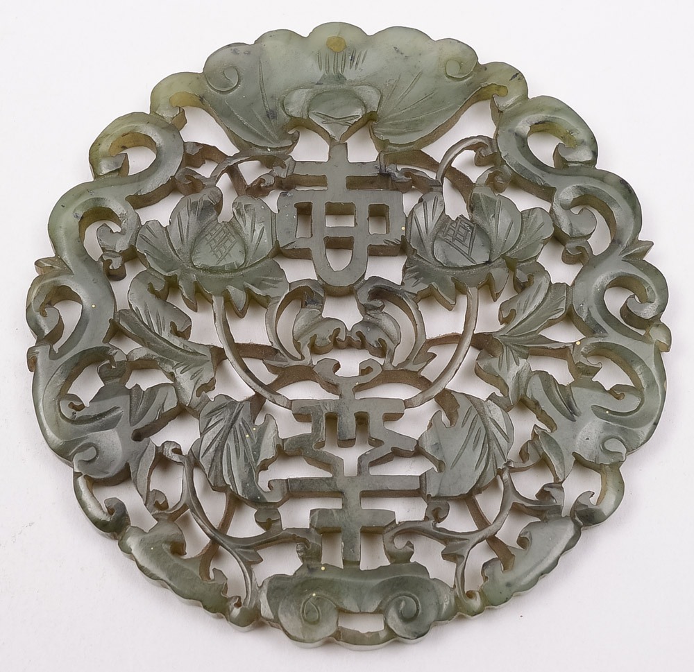 A Chinese carved pale green jade disc: o