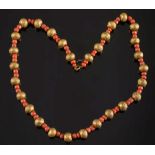 An antique gold and coral  bead single-s