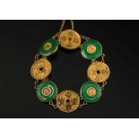 A Chinese gold and green jade disc panel