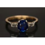 A sapphire and diamond three-stone ring: