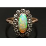 An opal and diamond oval cluster ring:,