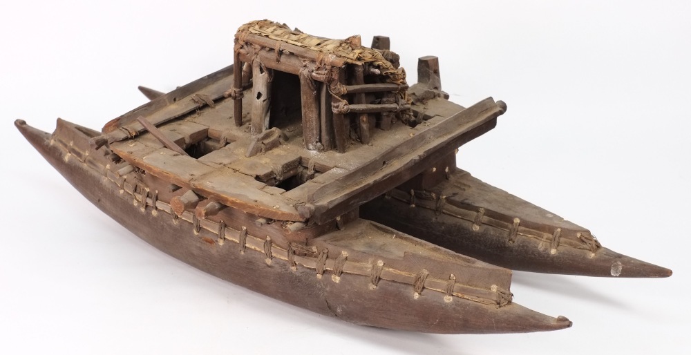 A 19th century Pacific wooden model of a tribal catamaran:,