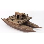 A 19th century Pacific wooden model of a tribal catamaran:,